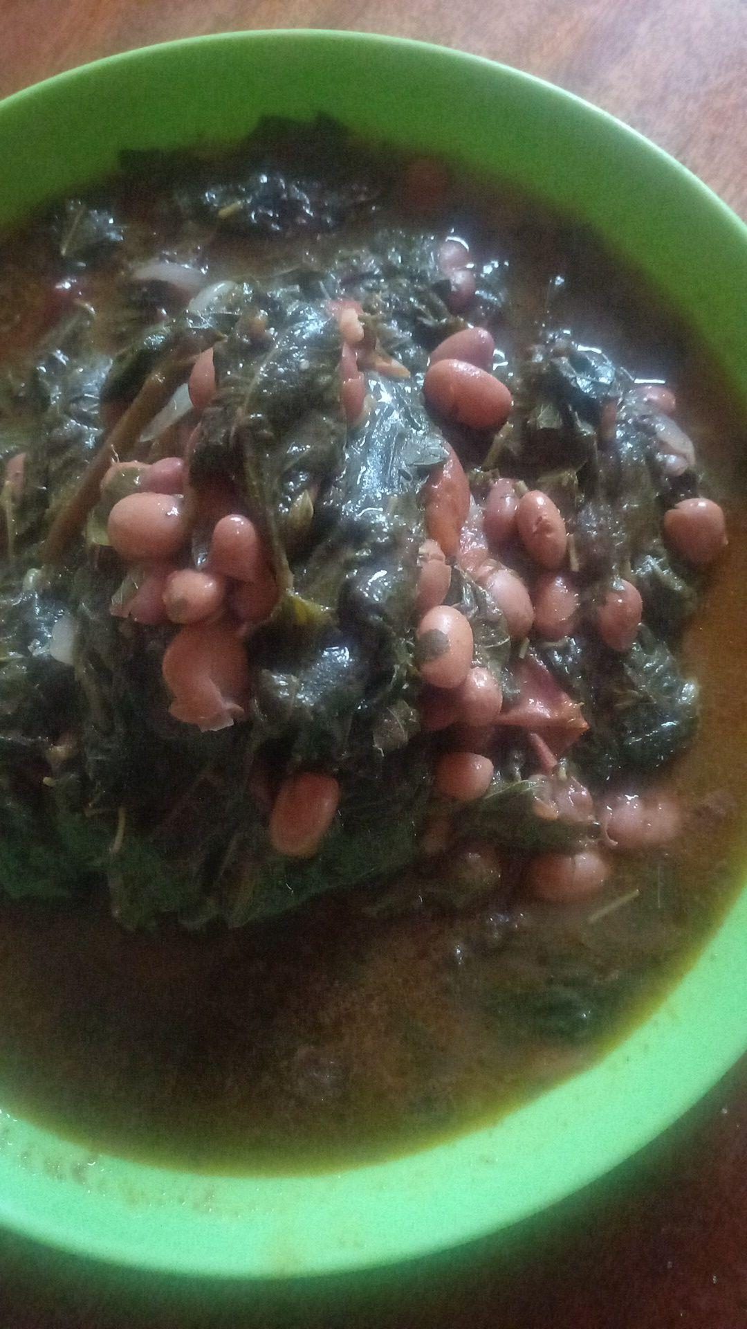 A finished meal of greens and beans cooked from the harvest